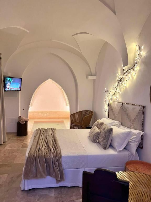 Vaulted suite interior with a double bed and warm lighting at Zahra Superior Suite
